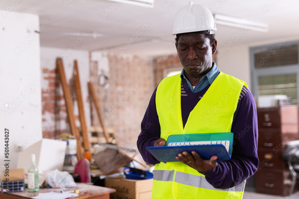 Responsible african american supervisor in yellow safety vest and hard ...