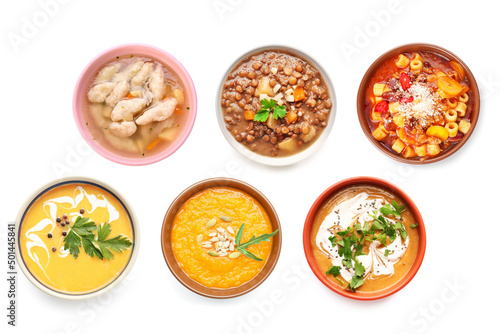 Set of tasty soups in bowls on white background, top view