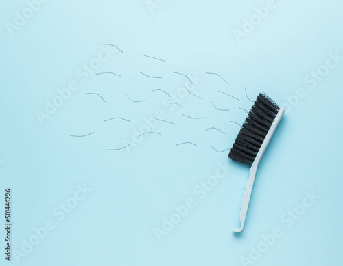 A collapsing cleaning brush on a blue background. Flat lay.