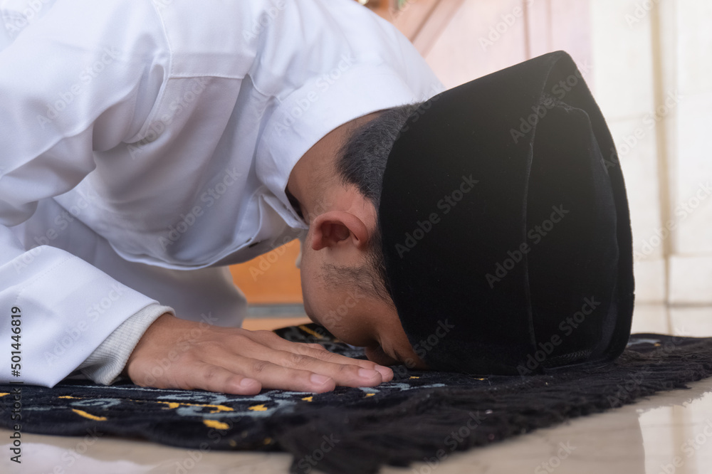 Portrait of a Muslim man praying in an act of prostration called Sajdah ...