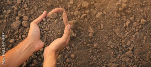 Hands of farmer with heap o...