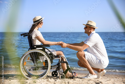 Young man and his girlfriend with physical disability at sea resort © Pixel-Shot