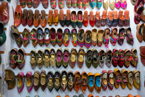 Pairs of colorful Rajasthani womens' shoes at display for sale. Jaisalmer, Rajasthan, India.