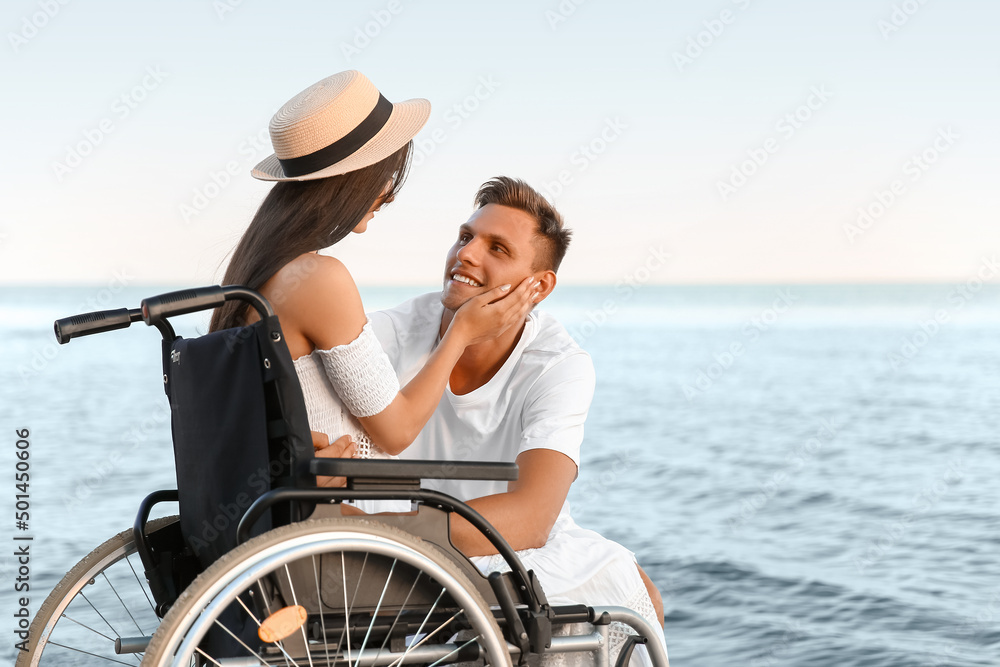 Happy woman with physical disability and her boyfriend at sea resort Happy woman with physical disability and her boyfriend at sea resort