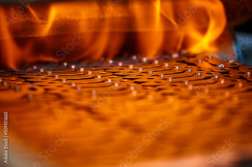 Fototapete Annealing powdered details with burning flame in furnace