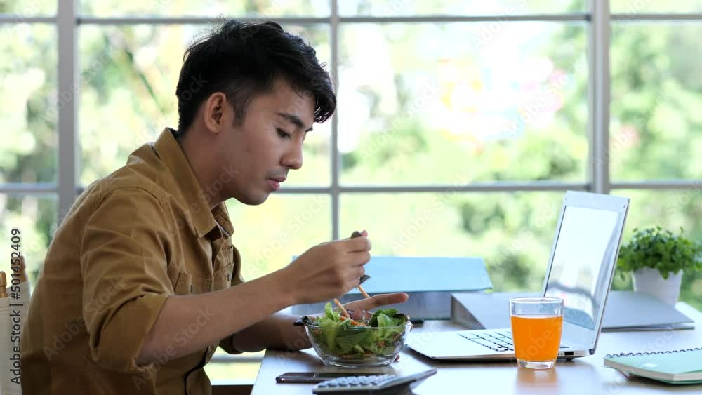 Asia man working and eating at home Asia man working and eating at home
