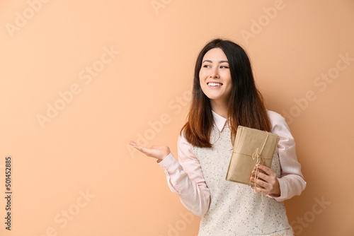 Young Asian woman with stac...