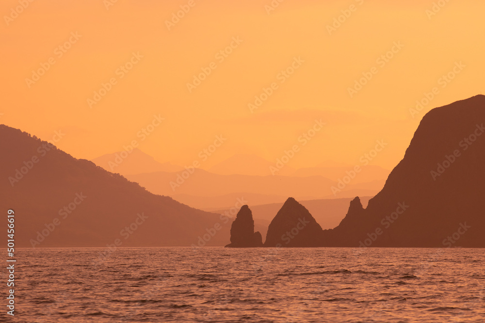 Abstract orange sunset mountains and sea natural background