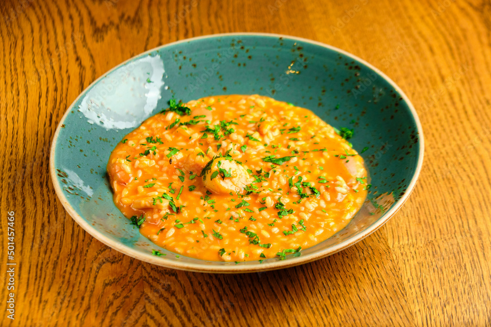 Tomato Risotto on a white restaurant plate. Tomato Risotto on a white restaurant plate.