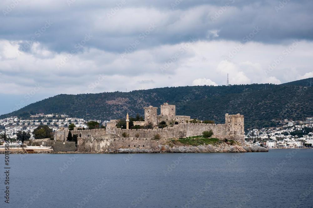 Bodrum Castle sea view with dramatic clouds on a grey day. Beautiful Tourist banner or poster background with copy space.  A historical fortification and popular tourist destination in Turkey.