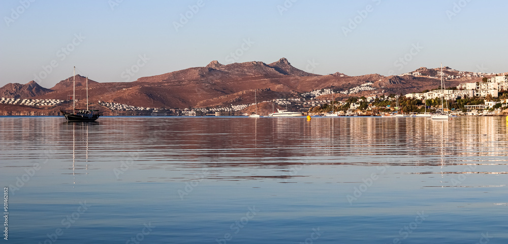Blue sea, islands and boats on the Aegean coast. Summer vacation and coastal nature concept