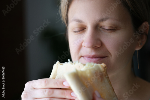 Happy woman with closed eyes holding white bread