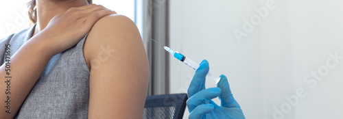 Vaccination of patients, Doctor provided a vaccine with a syringe against a new strain of virus or influenza in a modern hospital, Prevention and health care concept.