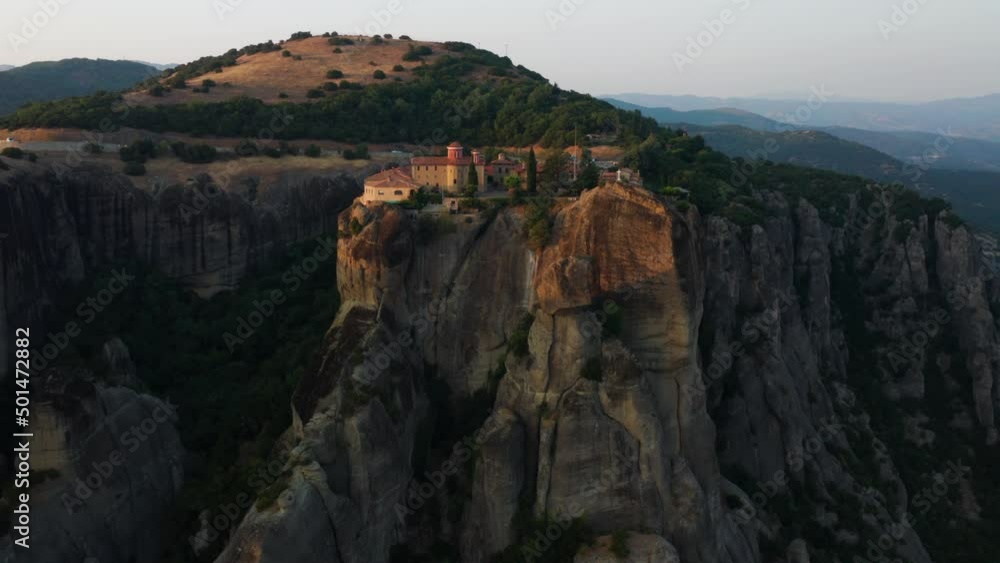 Monastery Of St Stephan Perching On The Rock Formation In Meteora, Greece - aerial drone shot Monastery Of St Stephan Perching On The Rock Formation In Meteora, Greece - aerial drone shot