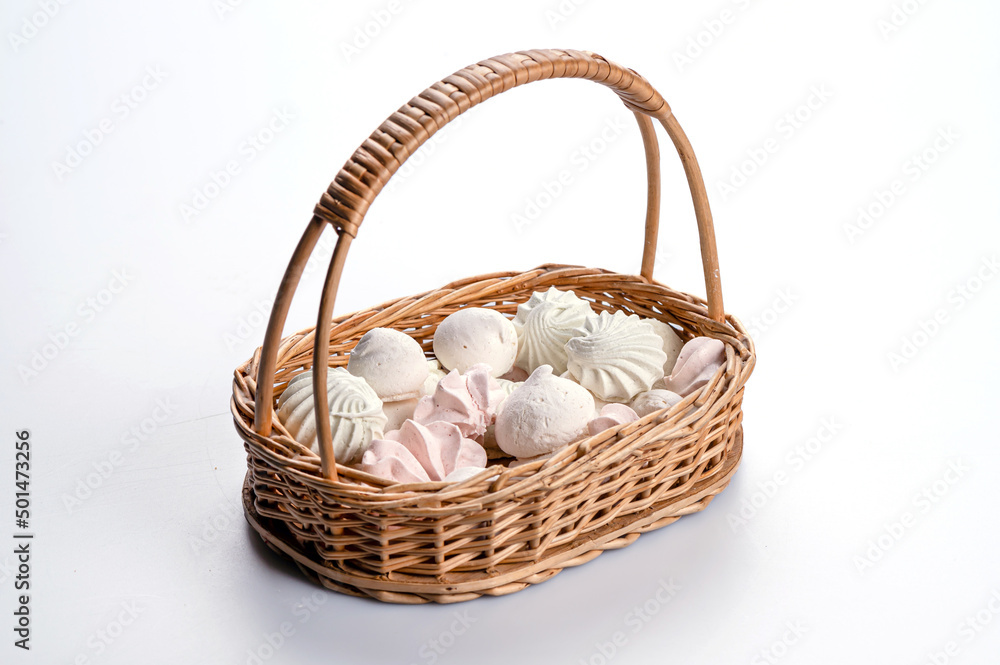 wicker basket with meringue cookies from egg whites, selective focus, closeup, isolated, copy space wicker basket with meringue cookies from egg whites, selective focus, closeup, isolated, copy space