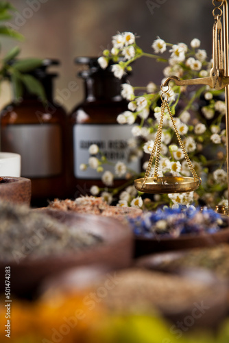 Alternative medicine  dried herbs and mortar on wooden desk background