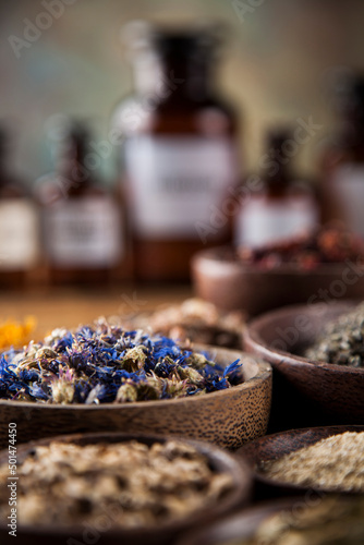 Herbs medicine and vintage wooden desk background