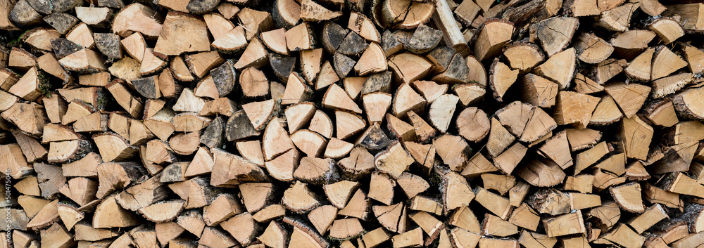 Background of stacked chopped wood logs. Pile of wood logs ready for winter. Wooden stumps, firewood stacked in heap Background of stacked chopped wood logs. Pile of wood logs ready for winter. Wooden stumps, firewood stacked in heap