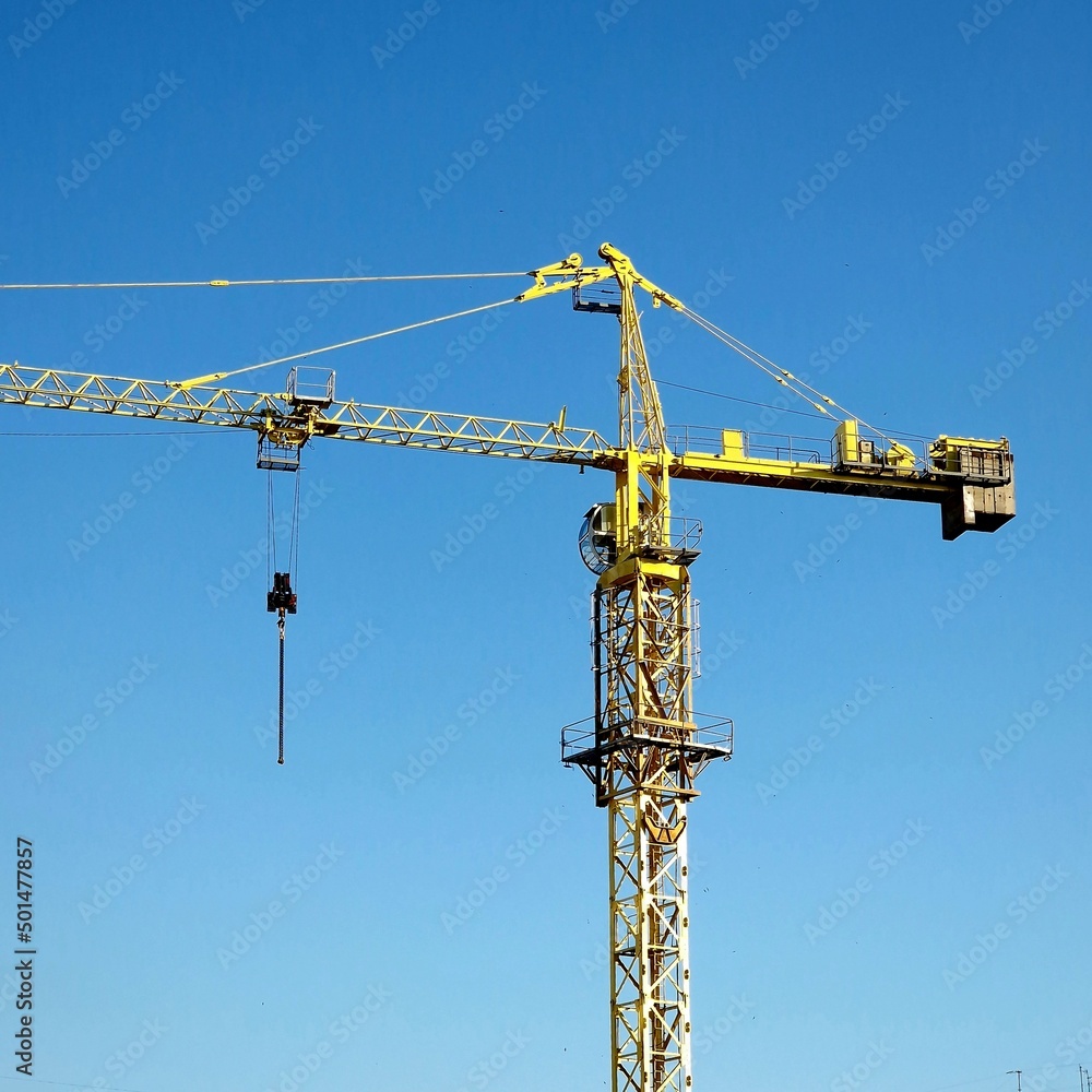 a fragment of a crane stands against the background of a blue sky a fragment of a crane stands against the background of a blue sky