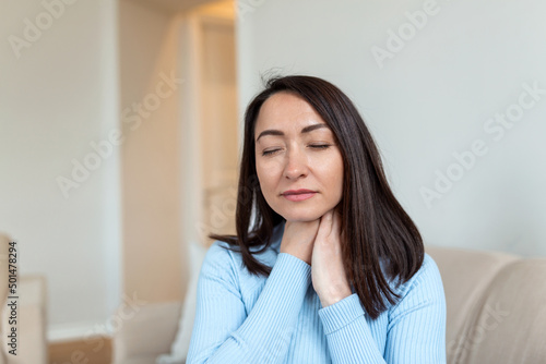 Close up of Asian woman rubbing her inflamed tonsils, tonsilitis problem, cropped. Woman with thyroid gland problem, touching her neck, girl has a sore throat Free Download Close up of Asian woman rubbing her inflamed tonsils, tonsilitis problem, cropped. Woman with thyroid gland problem, touching her neck, girl has a sore throat - GFXLoad
