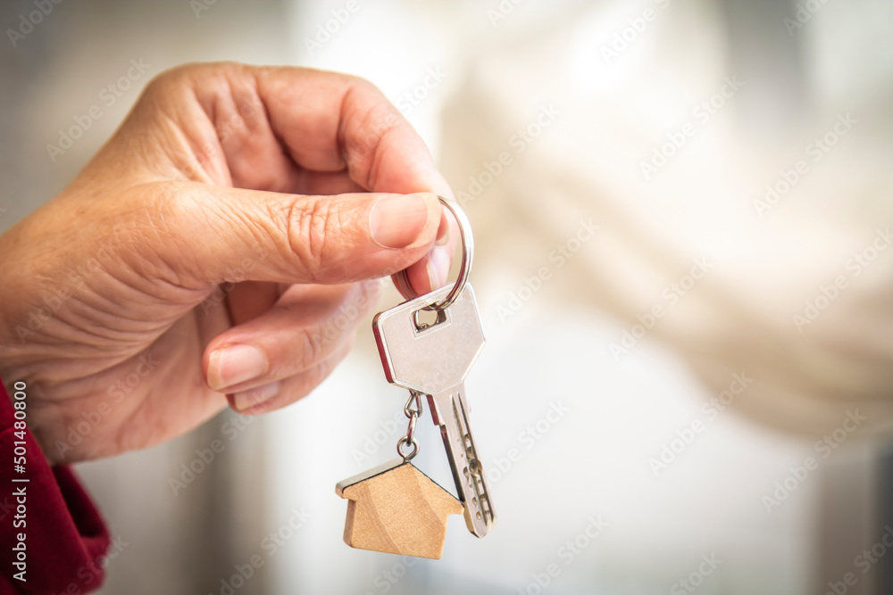 hand holding keychain with house or apartment keys hand holding keychain with house or apartment keys