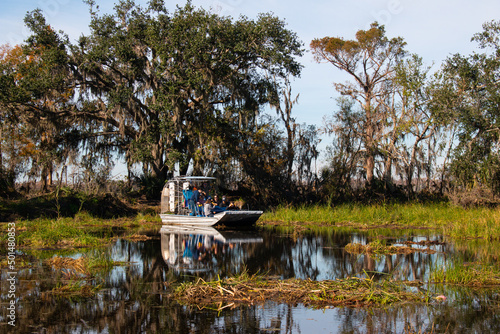 A tour airboat is looking for alligators in the swamps near New Orleans, Louisiana, January 2022