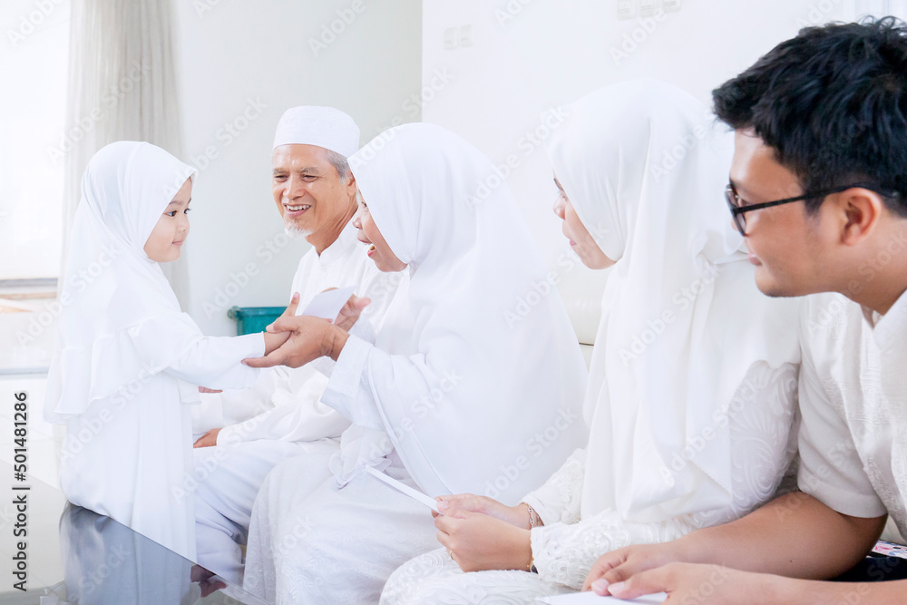 Muslim little girl get money envelope from family Muslim little girl get money envelope from family