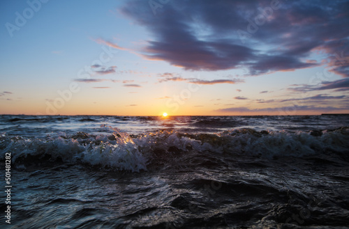 Beautiful ocean sunset with wave splashing out