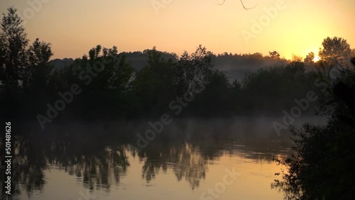 River in the morning in a beautiful fog. Beautiful lake in the evening, sunset against the backdrop of the sun