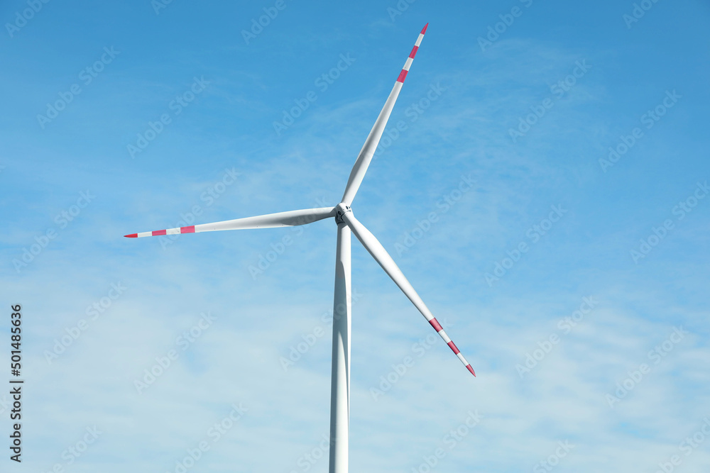 Modern wind turbine against blue sky. Alternative energy source Modern wind turbine against blue sky. Alternative energy source