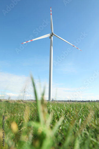 Modern wind turbines in field on sunny day. Alternative energy source © New Africa