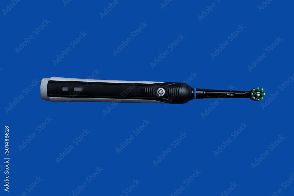 Fototapeta premium Closeup of Electric toothbrush isolated on blue background