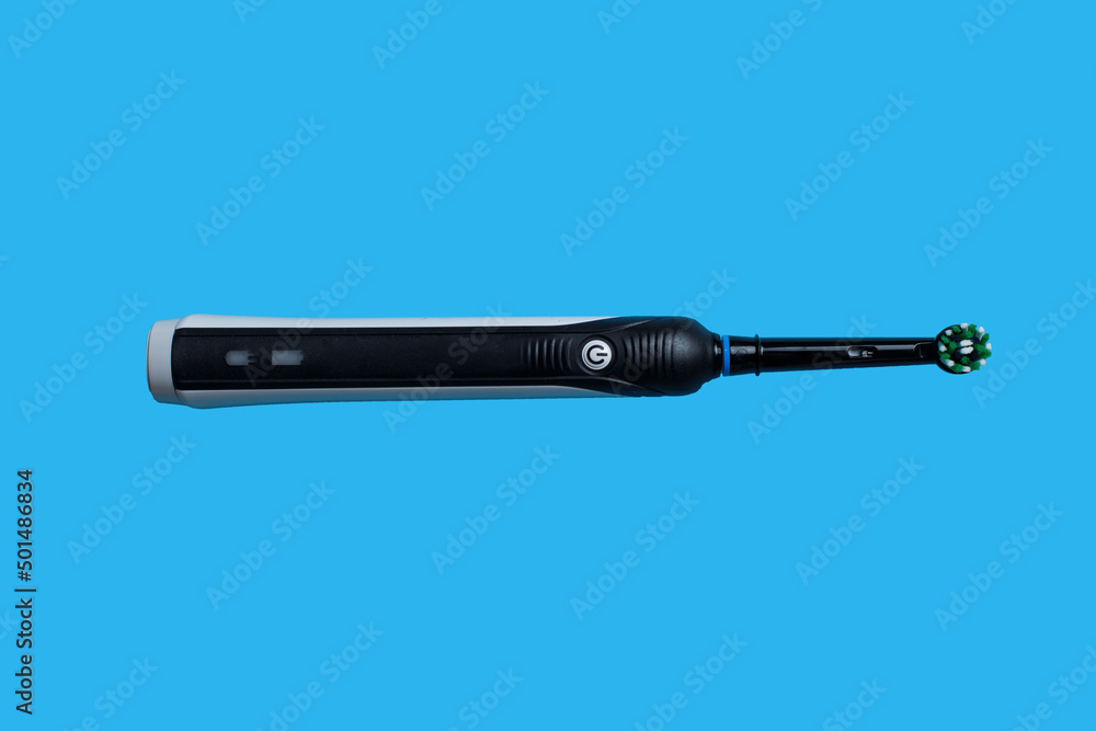Fototapeta premium Closeup of Electric toothbrush isolated on blue background
