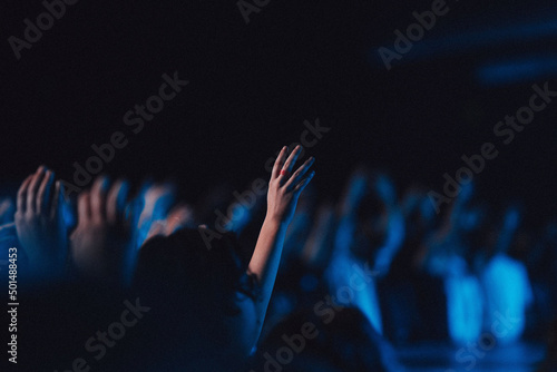 Canvas Print Believers in worship gathered in a hall with blue light effect