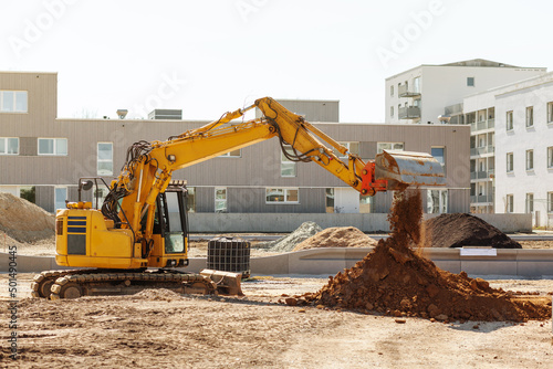 Excavator Working on Construction Site. Crawler Excavator Throws Ground on pile on Urban Place. Tillage with excavator