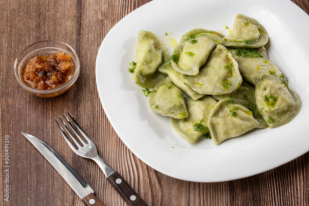 Traditional ukrainian dish vareniki served in a bowl with greaves and basil sauce. Close up view of traditional Ukrainian food. Traditional ukrainian dish vareniki served in a bowl with greaves and basil sauce. Close up view of traditional Ukrainian food.
