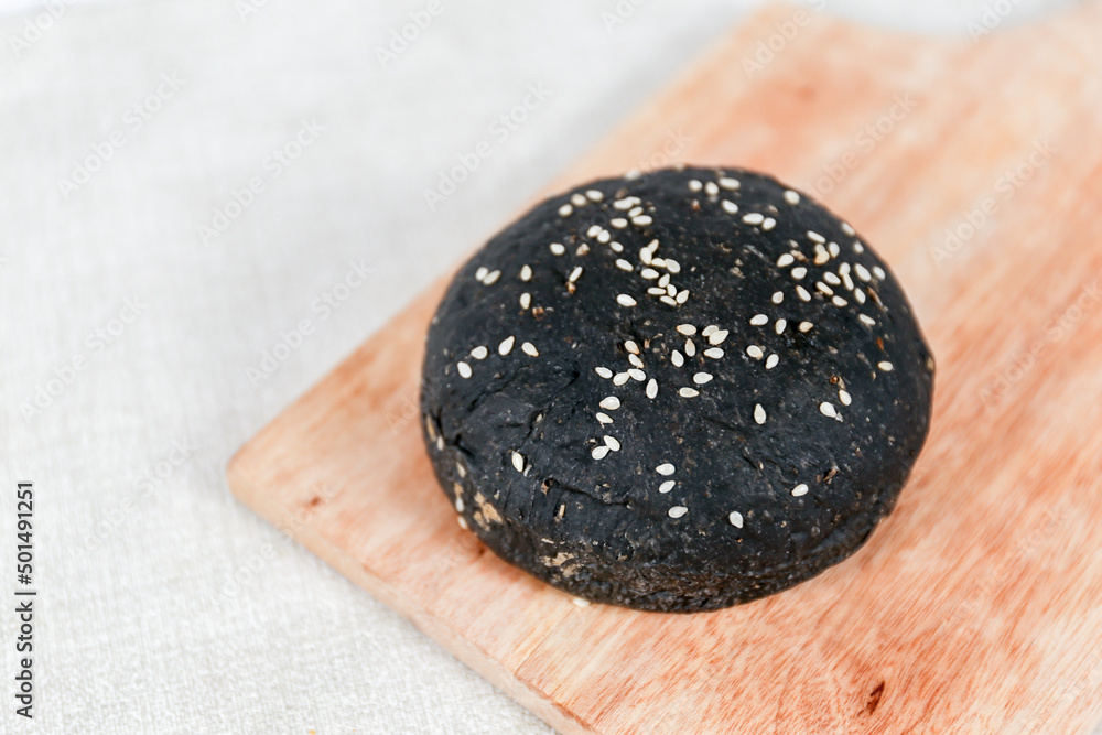 Black burger buns with sesame set with copy space for text Black burger buns with sesame set with copy space for text