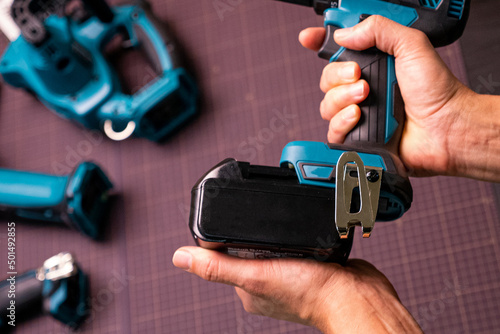 repairman changing the battery in a screwdriver photo