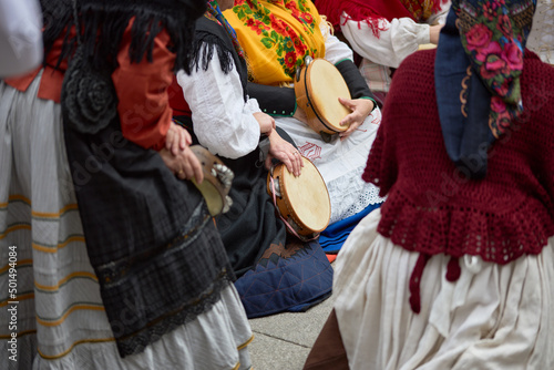 Fototapeta Closeup of Women playing tambourines at a popular festival in the city of Vigo