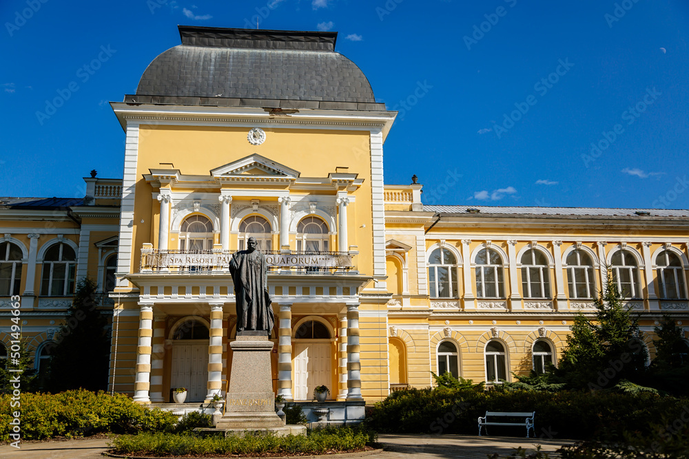 Frantiskovy Lazne, Western Bohemia, Czech Republic, 14 August 2021: Neo-Renaissance building Imperial Baths in park of great famous spa town Franzensbad, Monument to Francis Joseph I, sunny day