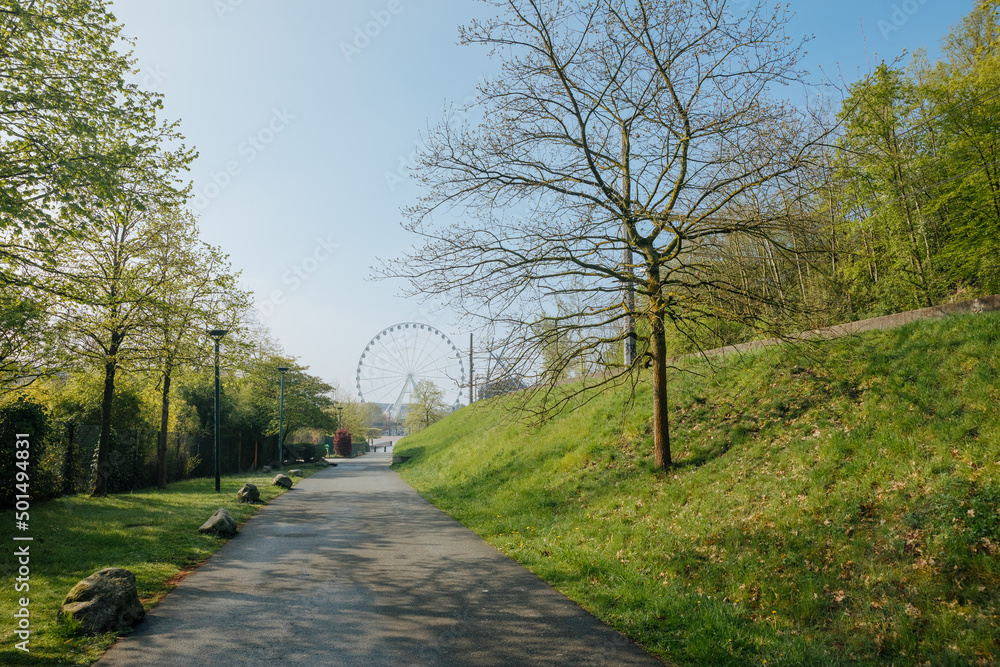 a big wheel in the summer. Ferris wheel in a green city. amusement park in Germany a big wheel in the summer. Ferris wheel in a green city. amusement park in Germany