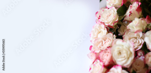 Wedding, birthday stationery mock-up scene. Blank paper greeting card, invitation. Decorative floral composition. Closeup of pink roses petals. Mock up with empty space. © Elena