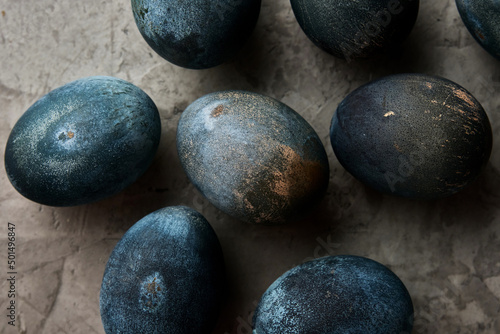 eggs painted in the color of concrete lie on a gray background