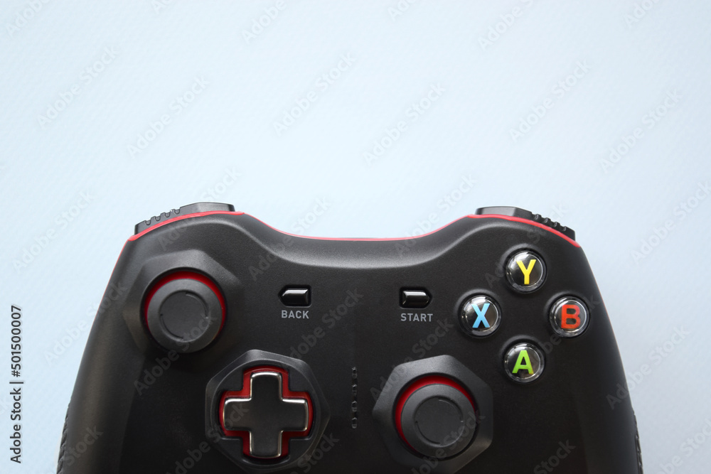 Two joystick gaming controller on light blue background. Minimalism. Two joystick gaming controller on light blue background. Minimalism.