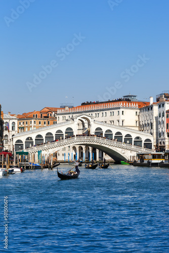 Venice Rialto bridge over Canal Grande with gondola travel traveling holidays vacation town portrait format in Italy