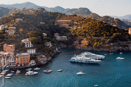 Liguria, Italy, Europe. Luxury yachts and boats in The beautiful Portofino with colorful houses and villas, in little bay harbor.