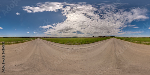 full seamless spherical hdri 360 panorama view on no traffic gravel road among fields in summer day with awesome clouds in equirectangular projection, ready for VR AR