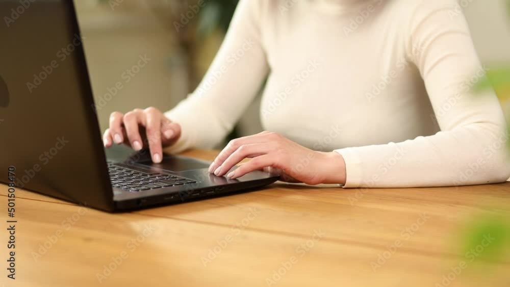 Close up female hands searching on laptop, woman working online