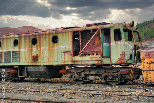 Old rusty abandoned train, greenish in color on some train rail, in the mines of riotinto