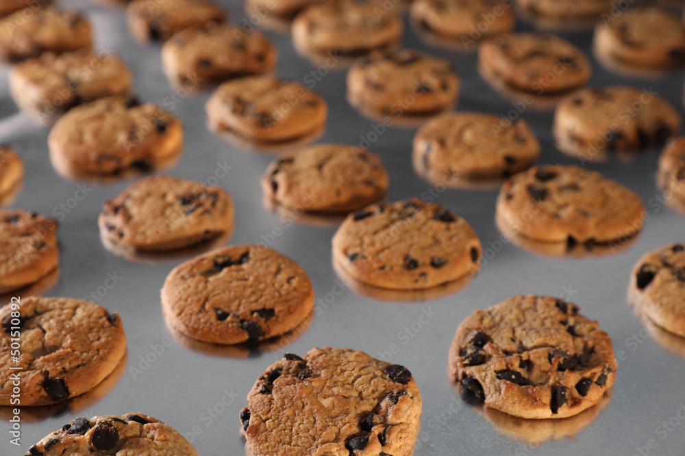 Many delicious cookies on production line, closeup Many delicious cookies on production line, closeup